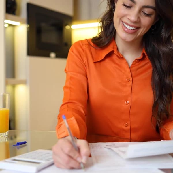 A woman seated at a table, contemplating her options for no credit check loans.